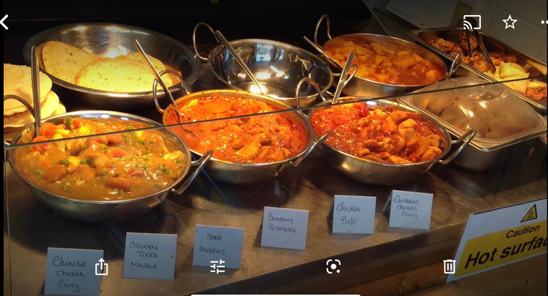 Caribbean cuisine with curry, jerk chicken and rice and peas