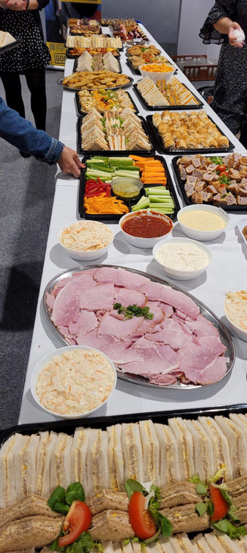 Hot and cold buffet spread with sandwiches, salads and appetisers
